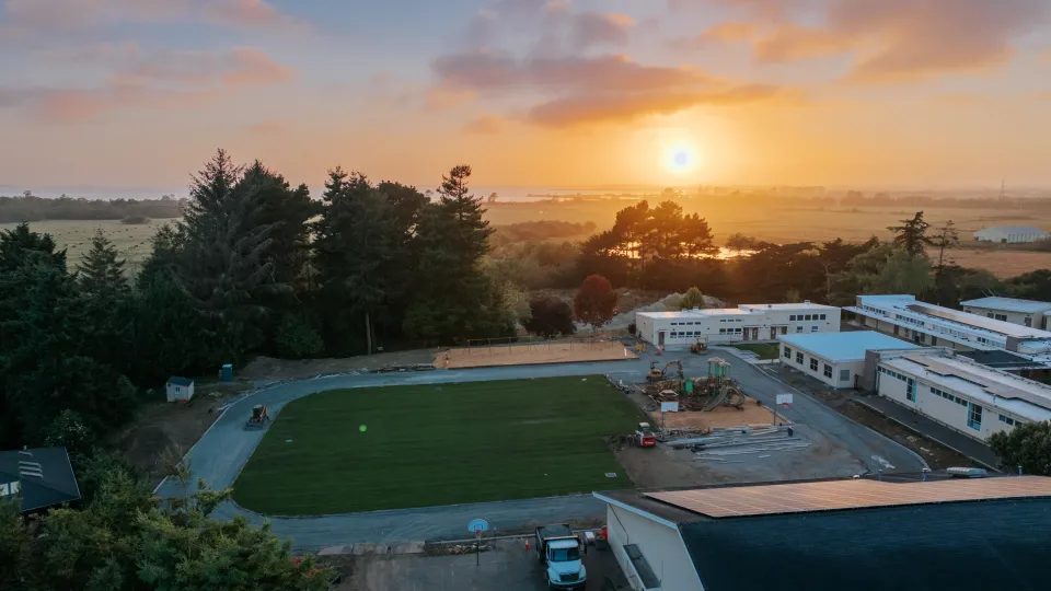 Aerial view at sunset over a newly installed school playing field