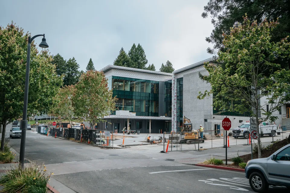 Street view of a modern commercial building with new sidewalk and landscape planting